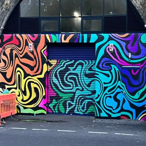 Gloss printed wall graphics on an external brick wall and shutter door using Mactac WW 319 PU vinyl.