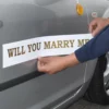 Magnetic Gloss White sign vinyl being applied to the side of someone's car, with cut-vinyl lettering applied to the film inviting some lucky person to "Marry Me?" ...