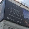 Matt Scrim print banner media for large format printed signage, used here to advertise stylish apartments for sales on the corner and sides of an ultra-large sized construction site.