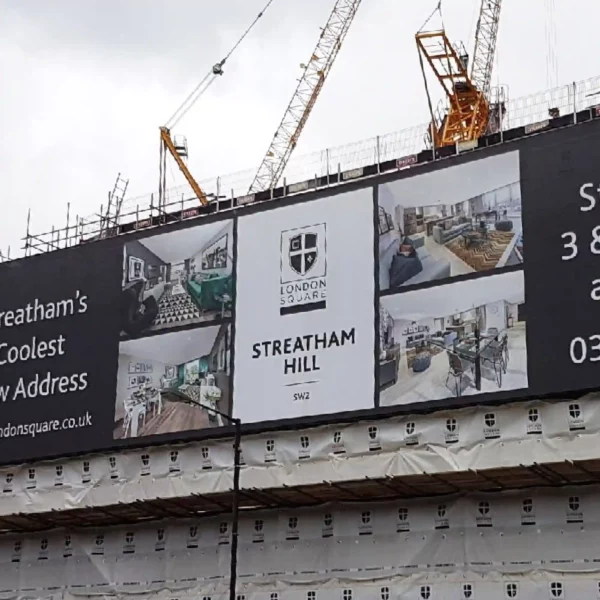 MESH280 printed mesh banner attached to the side of a large building wrap scaffold, advertising new apartments during the building site phase.