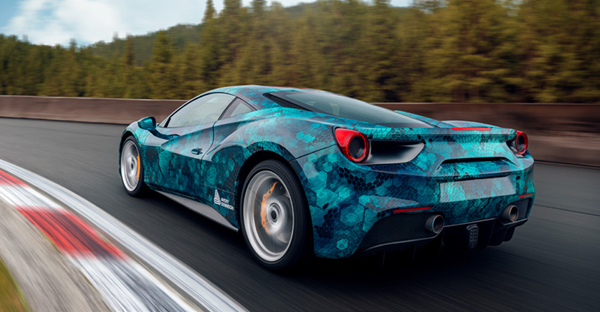 MPI 1105 EA RS, easy apply respsitionable and slideable digital cast print wrapping film with a printed blue honeycomb design fitted onto a sportscar is shown speeding around a race track with all the sharp contours and features accentuated brilliantly by the vinyl design.