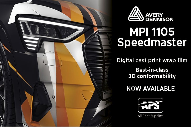 Avery Dennison MPI 1105 Speedmaster conformable cast wrapping film for digital printing in printed geometeric shapes of range, black and white wrapped onto a car showing close-up detail on the front grill, headlamp and wheel arch area.
