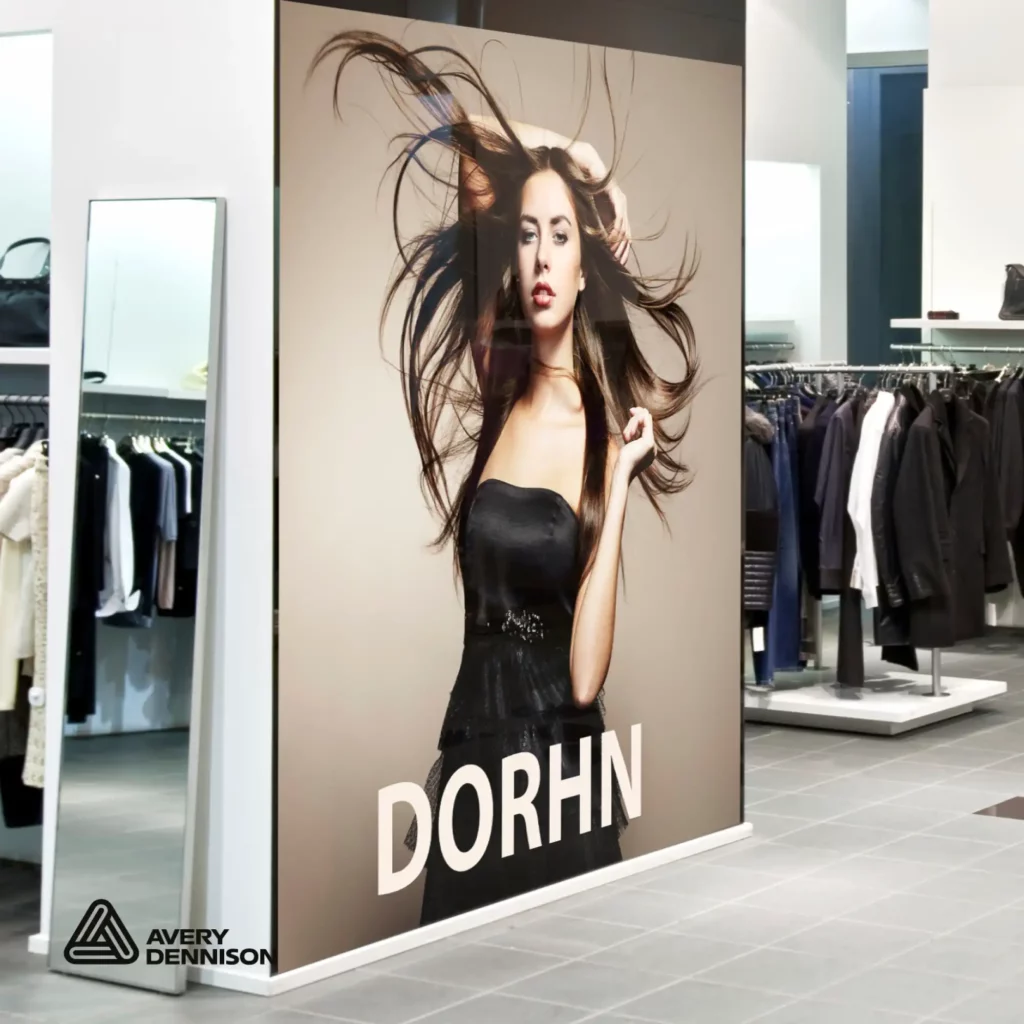 Avery Dennison MPI 2003 features a repositionable grey self-adhesive but is still part of the "Standard Opacity" series. A gloss white print vinyl for promotional display prints and large size graphics applied to a partition wall as part of the in-store advertising in this clothing retail store.