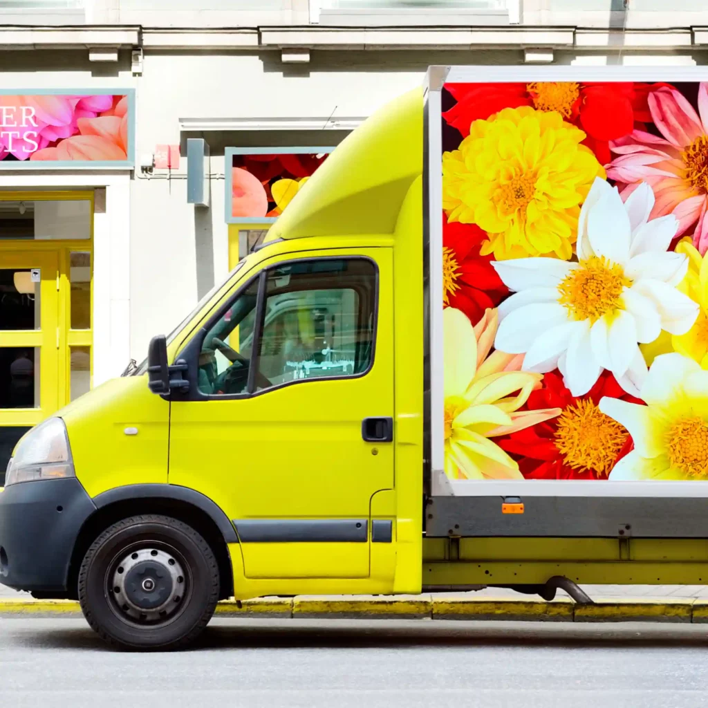 MPI 2004 HOP EA easy to apply opaque polyeric gloss white graphics film can be used for a wide variety of cover-over self-adhesive print application, such as used here applied to the flat sides of this florists box van with bright colourful floral imagery.