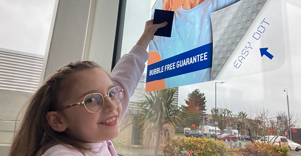 Neschen Easy Dot films are so easy to install, it's child's play! EASY-DOT PET Transparent L-UV ultra clear gloss self-adhesive polyester window graphics film is being applied to external glass by a 7 year old... simple, fuss free, no trouble!