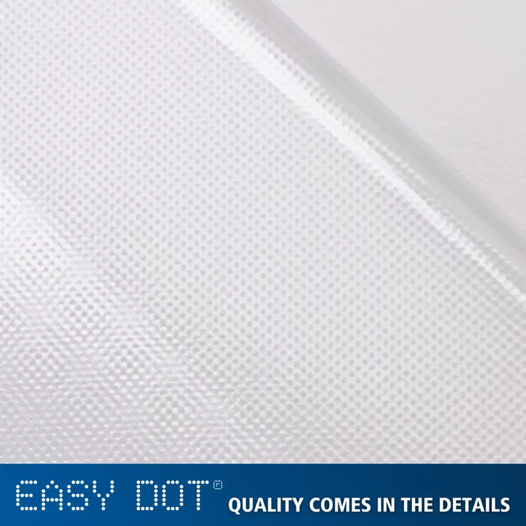 A close-up photo of Neschen's Easy Dot transparent, clear self-adhesive print film highlighting the unique dot adhesive pattern for easy, bubble-free applications. Text below sayas ' EASY DOT - quality comes in the details".