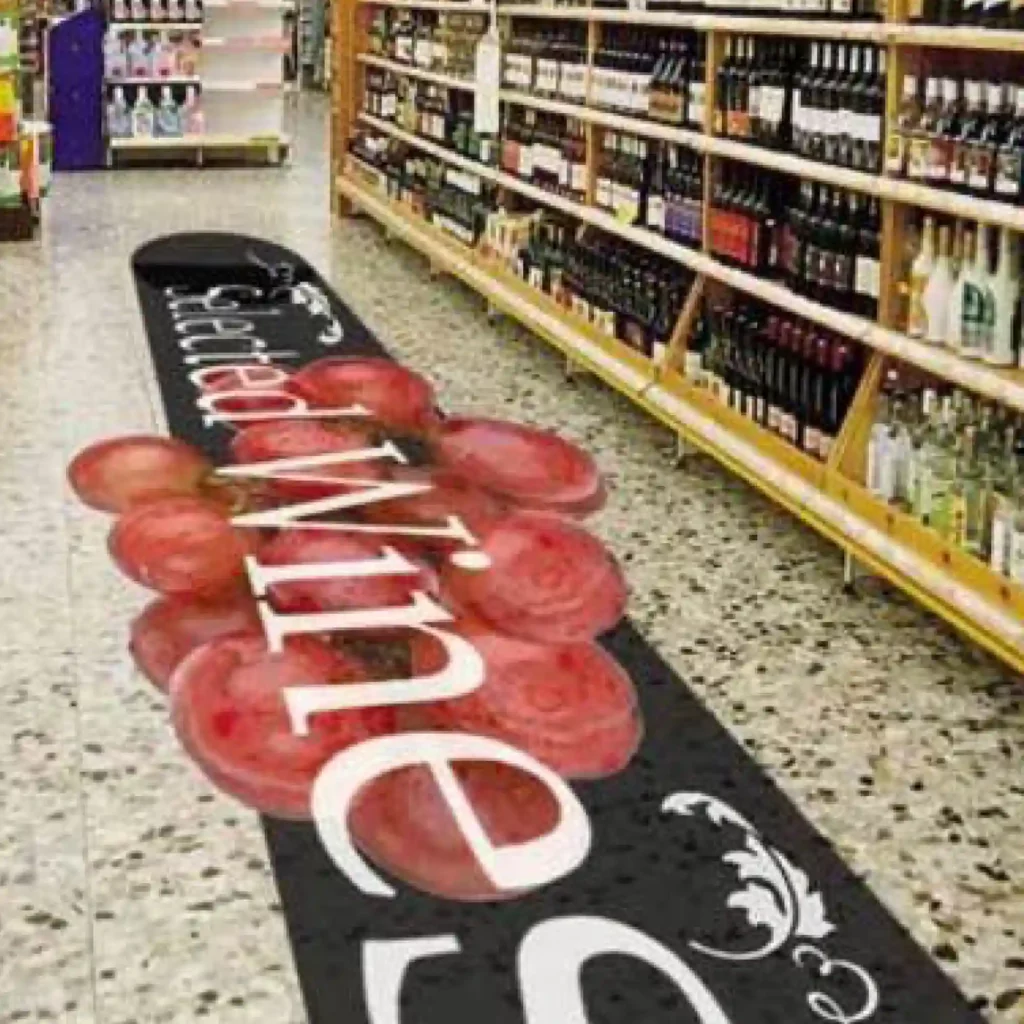 Neschen UV dot print 'n' walk, one-part floor graphic film printed with graphics for a wine promotion and applied along the centre of a supermarket aisle.