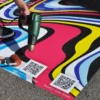 Nu-Coat M15-M print vinyl with extra strong self-adhesive being applied with a heatgun and soft rubber roller onto tarmac to create the strongest bond for outdoor floor graphics on more demanding, difficult to stick surfaces.
