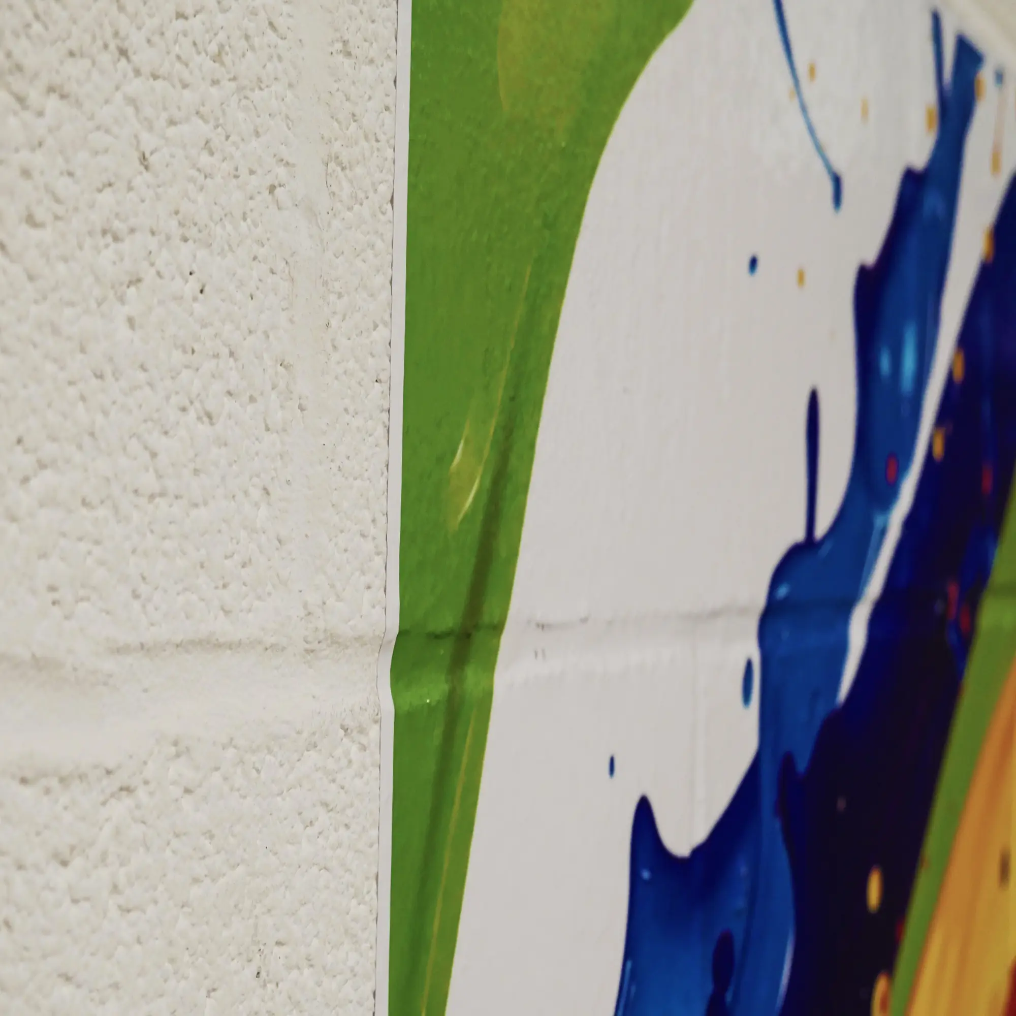 NU-COAT M16-U matt white print vinyl with UltraGRAB self-adhesive is designed for graphic applications onto rougher surfaces, and more demanding substrates such as shown in this photograph where a printed graphic has been adhered onto a painted white breeze block which has a textured surface.