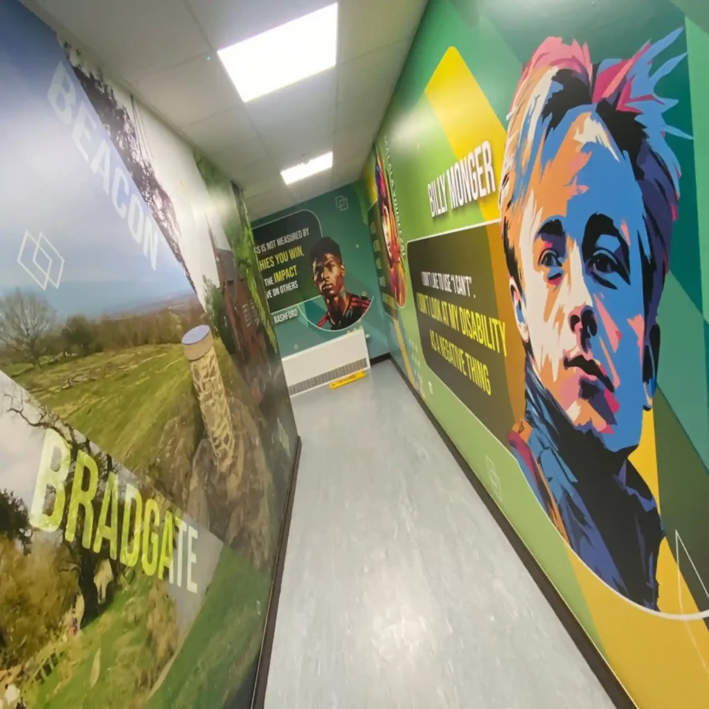 Looking down a long school corridor with educational and inspirational printed wallpaper graphics.