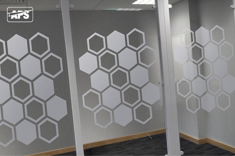 NU-COAT window etch film on an internal glass window with a silver etch hexagon honeycomb cutout design pattern that runs across the centre of the 3 corridor windows.