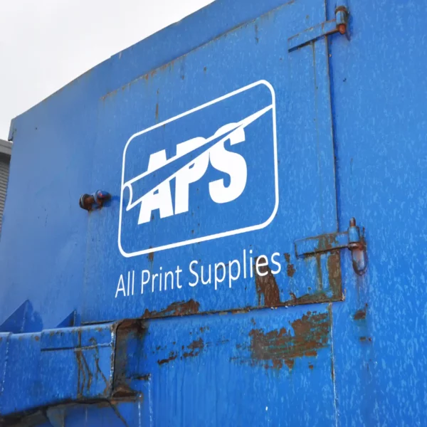 NU-COAT 'P' Series white sign vinyl cut-out All Print Supplies logo decal stuck to the side of an external skip door.