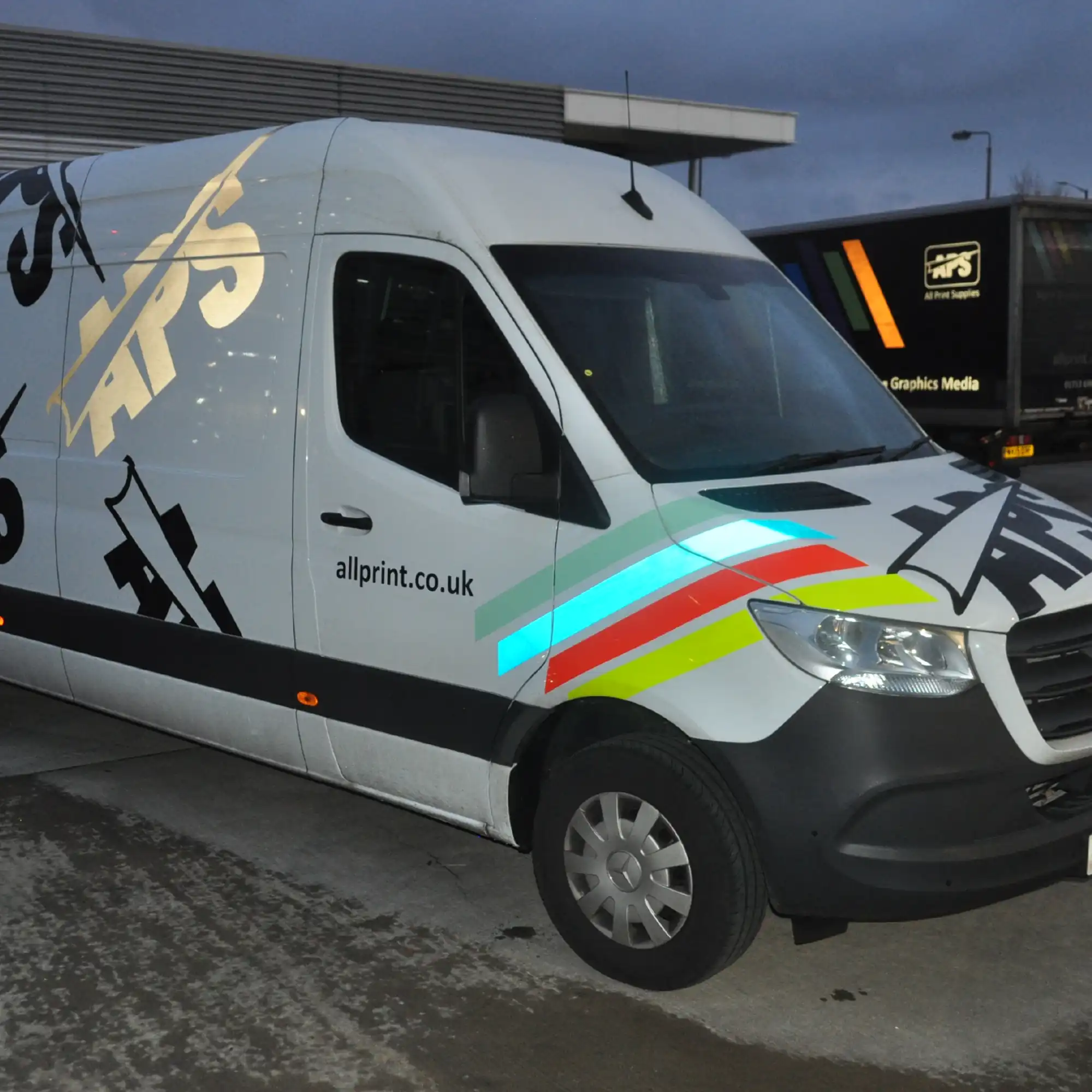 A couple of reflective vinyls from the ORALITE 5500 range of reflective sign vinyl colours, applied to one of the APS delivery vehicles with the blue and black decals reflecting impressively under the flash of the camera shining out on a dark evening light.