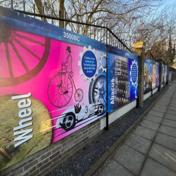 NU-COAT P12-H-P high grab polymeric print vinyl printed with educational display graphics that are informative and decorative, applied to hoardings that surround the exterior of a school fence.