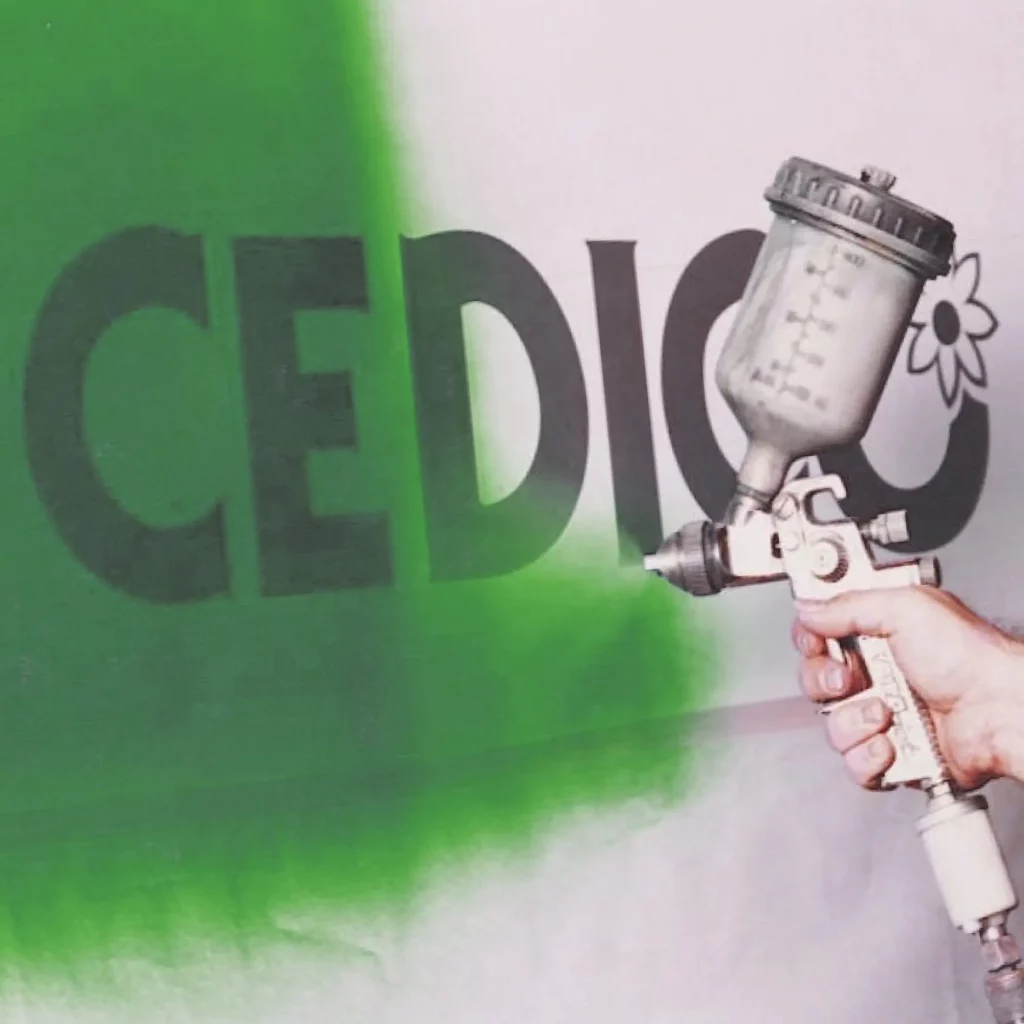 Overspraying the stencil graphic film with an artists air-spray gun, in this case using a green colour prior to removing the stencil from the surface after the spray colour is dry. Once MACmask 28.180 paint mask film is removed it leaves a fully coloured in graphic with clean and crisp edges.