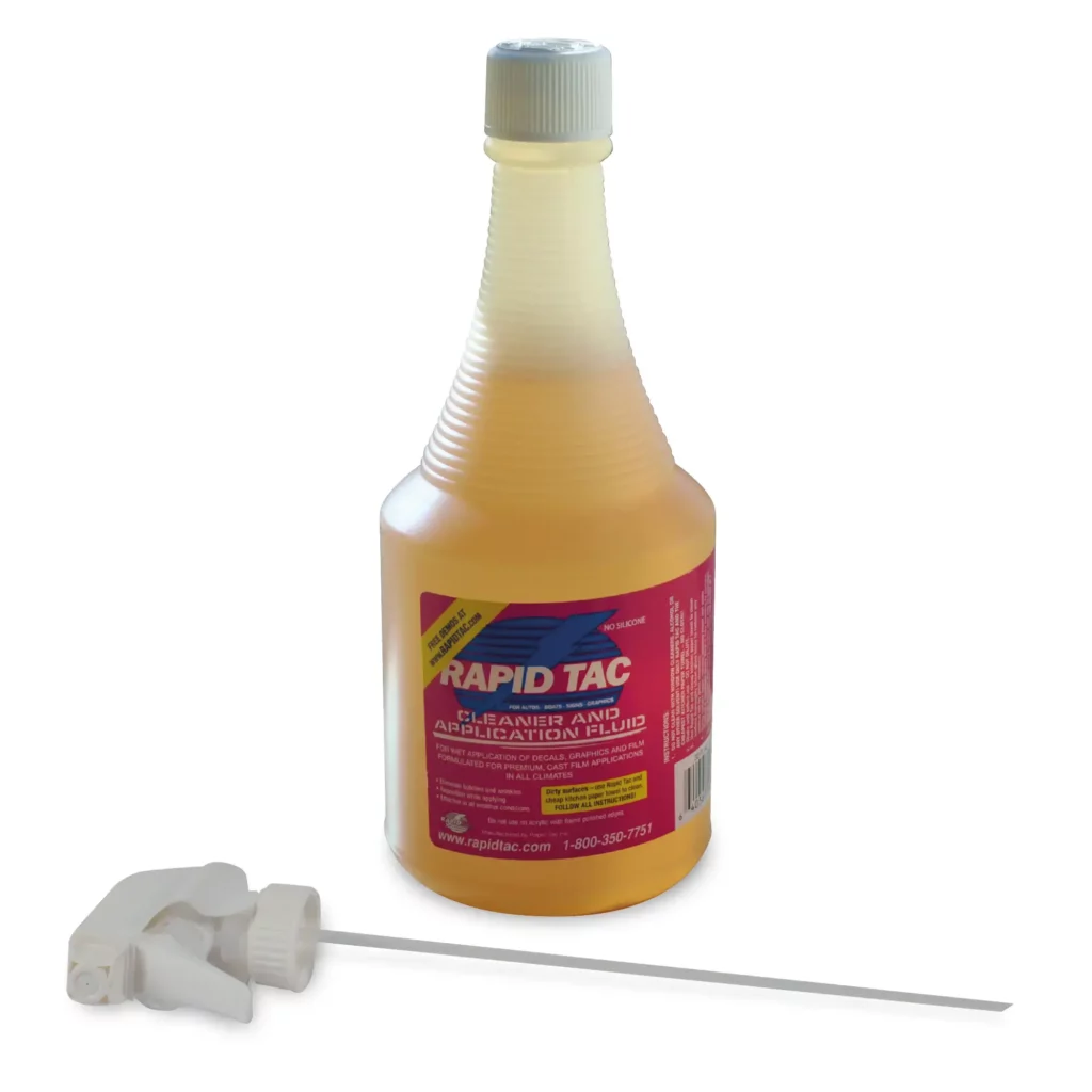 RAPIDTAC ORIGINAL pink coloured liquid application fluid for faster installation of graphics onto windows etc. in its' 946ml (32 Fl.Oz) bottle, which has a corrugated neck for easier gripping. The bottle has it's screw cap on the top rather than having the spray nozzle inserted. The spray trigger mechanism lays on its side at the foot of the bottle.