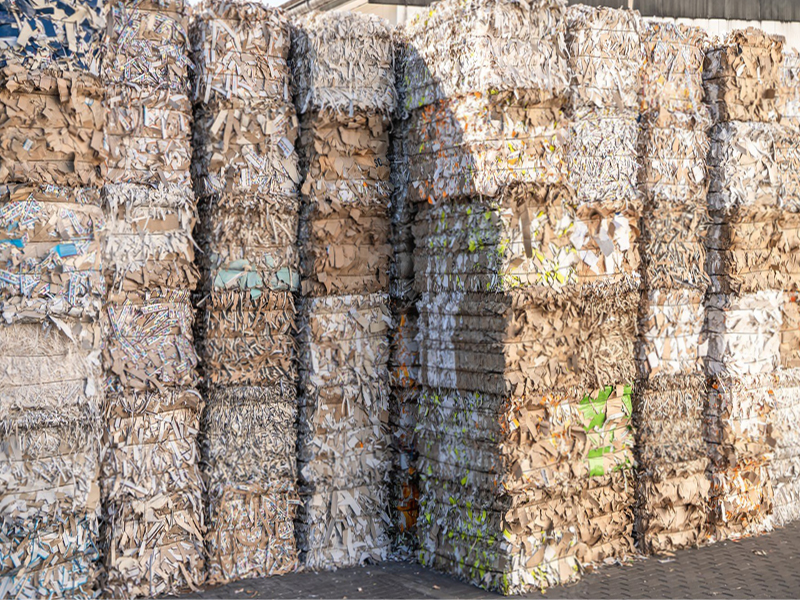 Well stacked bales of customer waste collected in the APS Collect & Recycle scheme; roll cores, paper and cardboard waste.