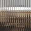 RG12 half-inch reeded glass pattern window obscurity film is pictured applied to a clear glass window with the wide shallow lens effect of the film providing a subtle wide ribbed effect providing decorative style and privacy to the window area.