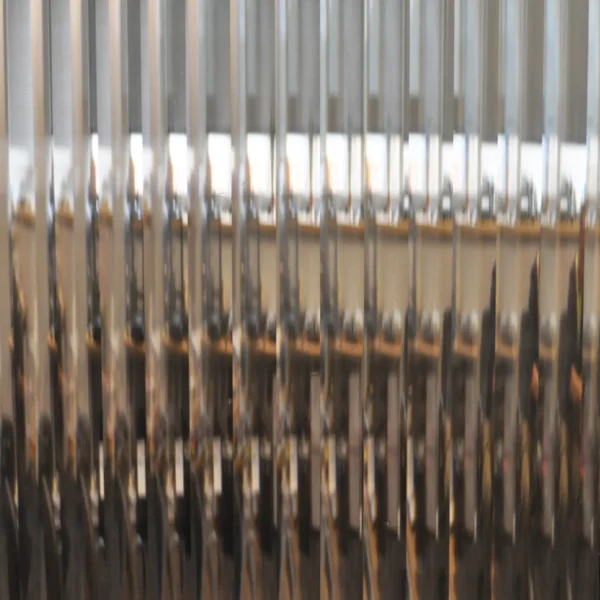 RG12 half-inch reeded glass pattern window obscurity film is pictured applied to a clear glass window with the wide shallow lens effect of the film providing a subtle wide ribbed effect providing decorative style and privacy to the window area.