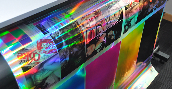 RH50 Rainbow Holographic Silver self-adhesive print film, with a shimmering full colour graphic being printed on a wide format printer.