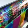 RH50 Rainbow Holographic Silver self-adhesive graphics film being printed full colour and reflecting a full spectrum of light colours from the metallic substrate giving an extra eye-catching dimension to the prints.