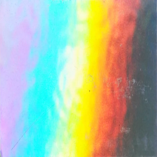 A close-up of the complete rainbow spectrum of colours being reflected from the surface of the unprinted surface of RH50 silver graphics film.