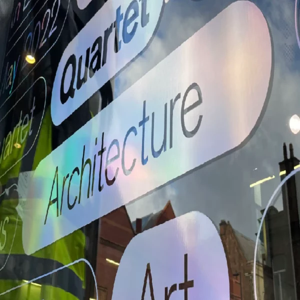 RH50 Silver Holographic cut-vinyl signage applied to high street window with a subtle metallised rainbow effect as the reflected light subtly changes the colour of the film.