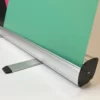 The base of the 'Buckingham' pull-up stand for exhibition banner graphics is super stable with elegant foldable feet, and looks great with it's aluminium metal and black plastic trim finish.