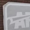 Positioning a very large and intricately cut-out self-adhesive vinyl graphic onto an exterior brick wall using RTape Conform 4078 RLA application tape to hold the vinyl design together and in position while fixing the graphic onto the surface.