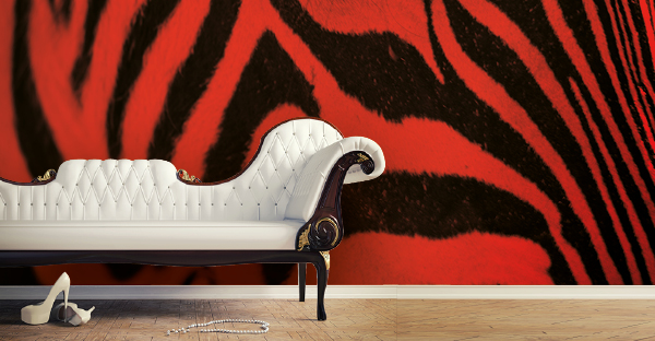Sihl 2512 printable non-woven pasteable wallpaper for custom printed decorative wall art, such as this rich red and black zebra fur style print, with a couch and personal belongings in front.