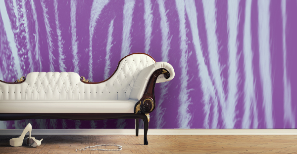 Sihl Design2Wall range of non-woven wallpapers are for decorators who wish to use custom printed wall art designs to give interior spaces a unique look, like this printed purple zebra image on the wall with an antique living room couch in the foreground.