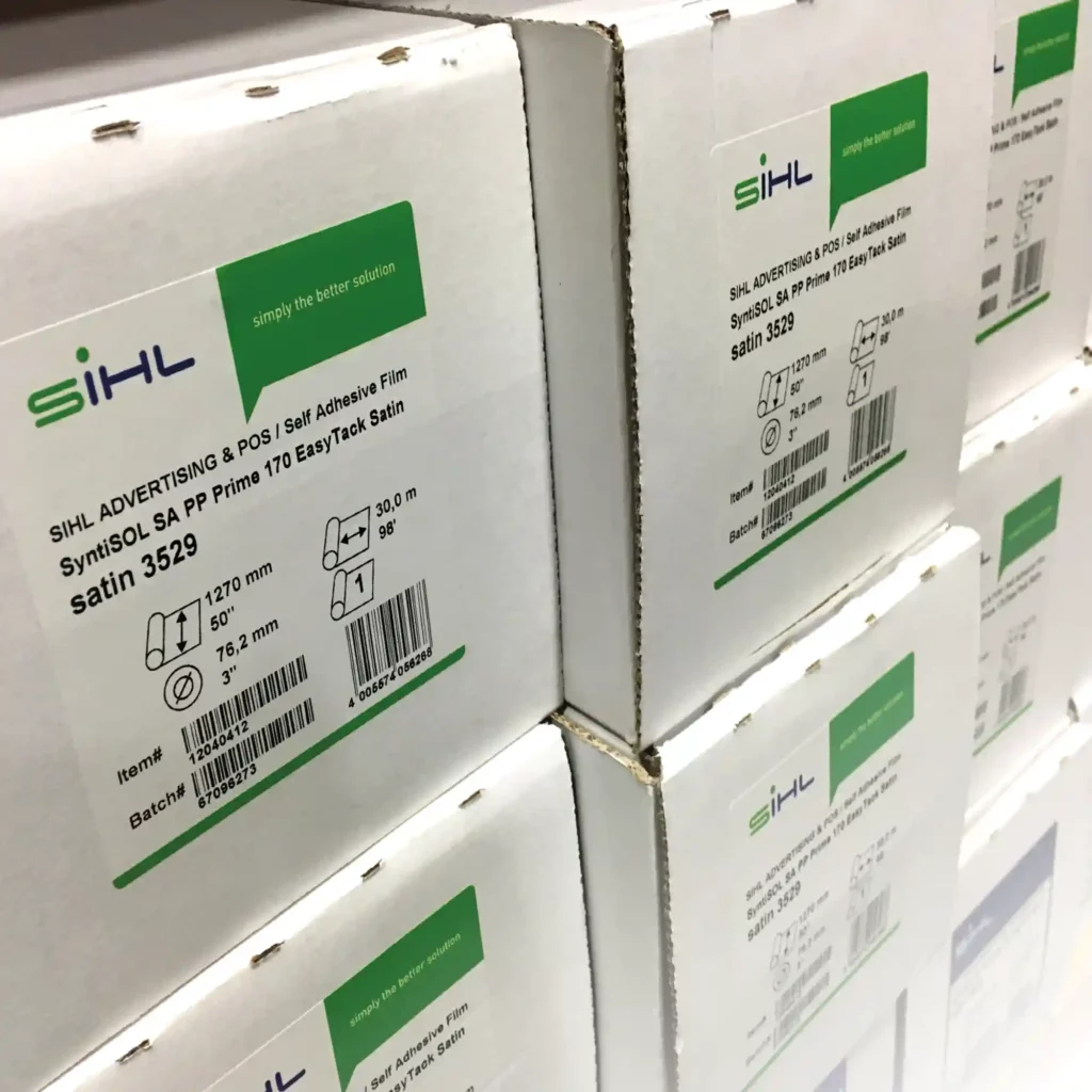Sihl 3529 SyntiSOL polypropylene print film with repositionable adhesive allows installers to easily move & reposition graphics - shown here is the branded white box packaging stacked in our warehouse ready to be called off from our stocks.