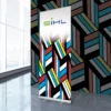 Sihl 3629 roll-up display print media, printed with All Print Supplies image sample graphics of colourful and bright striped geometric box patterns and the Sihl logo at the top of the banner, with matching, complimentary wall graphic images in the background.