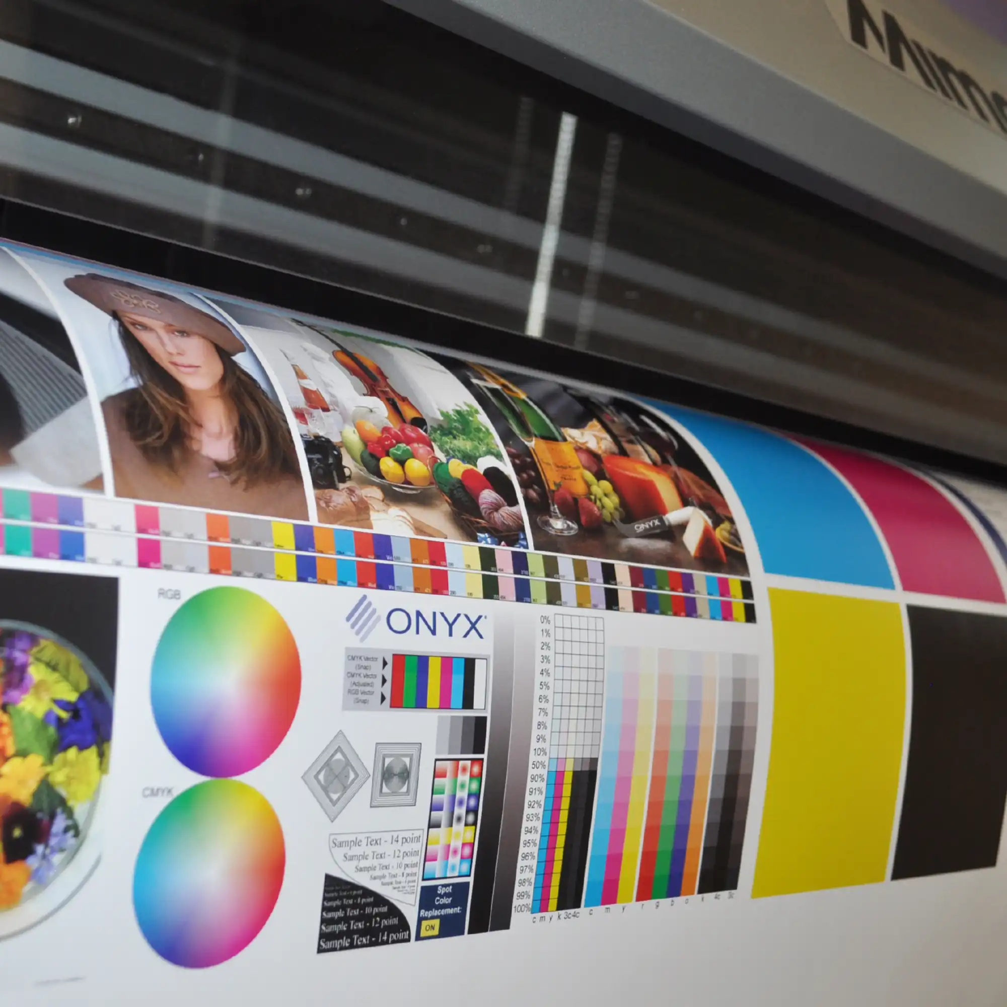 SIHL 3683 TriSOLV Primeart Blueback SA 210 billboard poster printing paper is shown with the roll media threaded through a wide format inkjet printer and vibrant colourful graphics being printed onto this opaque, cover-all white paper.