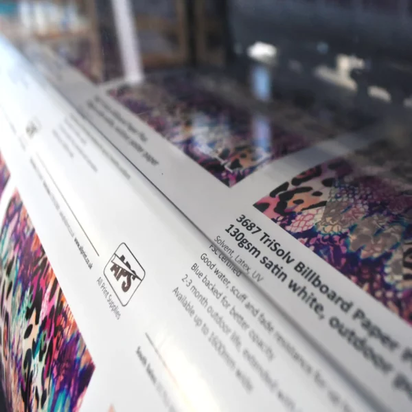 Durable outdoor billboard poster paper, Sihl 3687 TriSolv inkjet paper for high-quality wide-format digital printing on Solvent, Latex and UV digital inkjet printers, with a close-up detail of colourful imposed samples in the process of being printed.