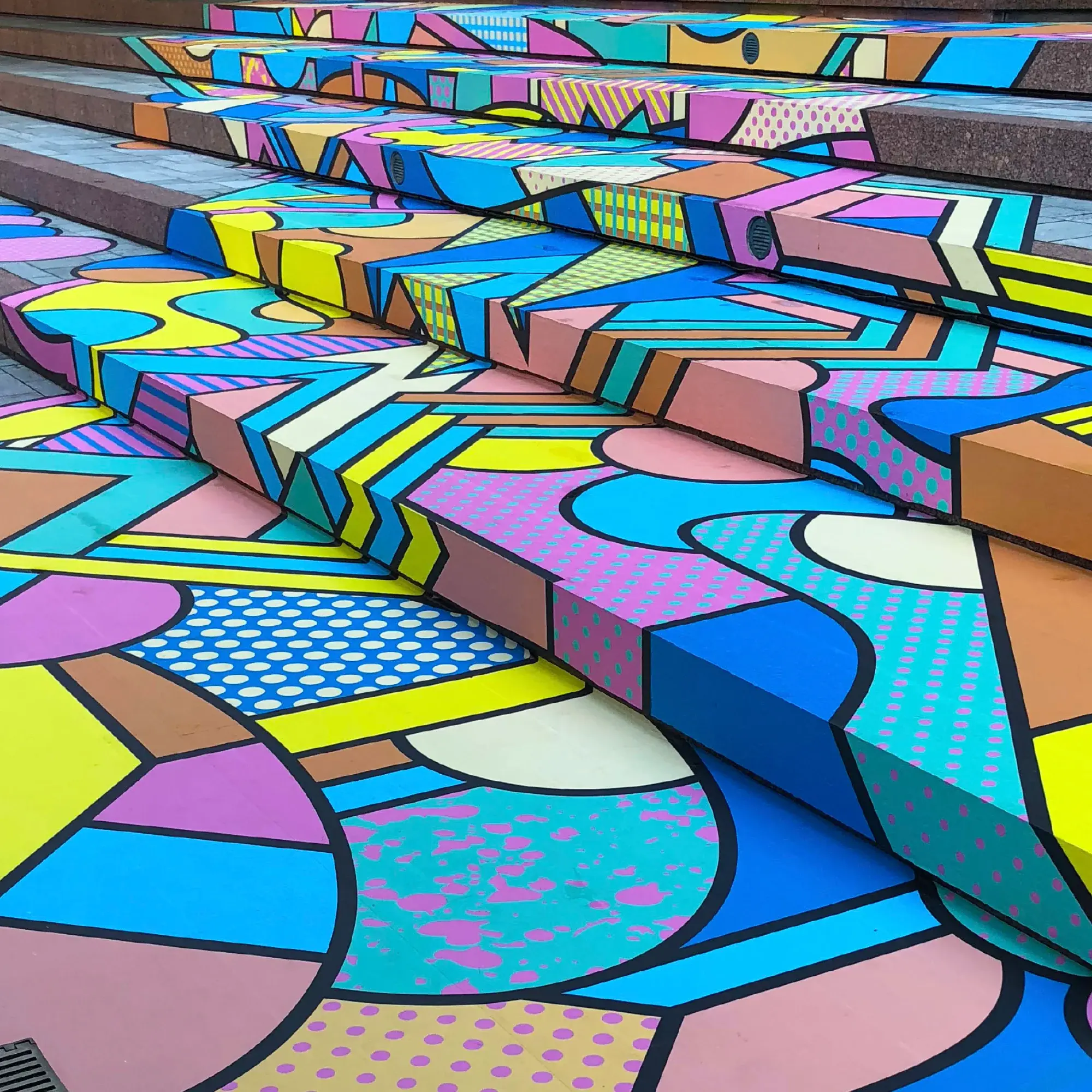 An abstract colourful design, printed onto self-adhesive floor graphics vinyl has been laminated with a slip-rated flooring laminate that is slip resistant and suitable for external use,