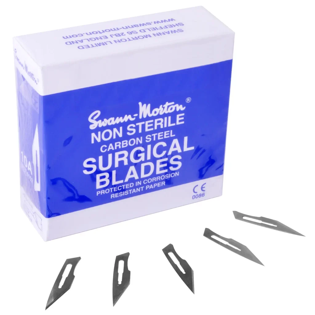 Swann Morton 10A replacement blades for the No. 3 steel scalpel handles fanned out in front of the branded blue and white box packaging.