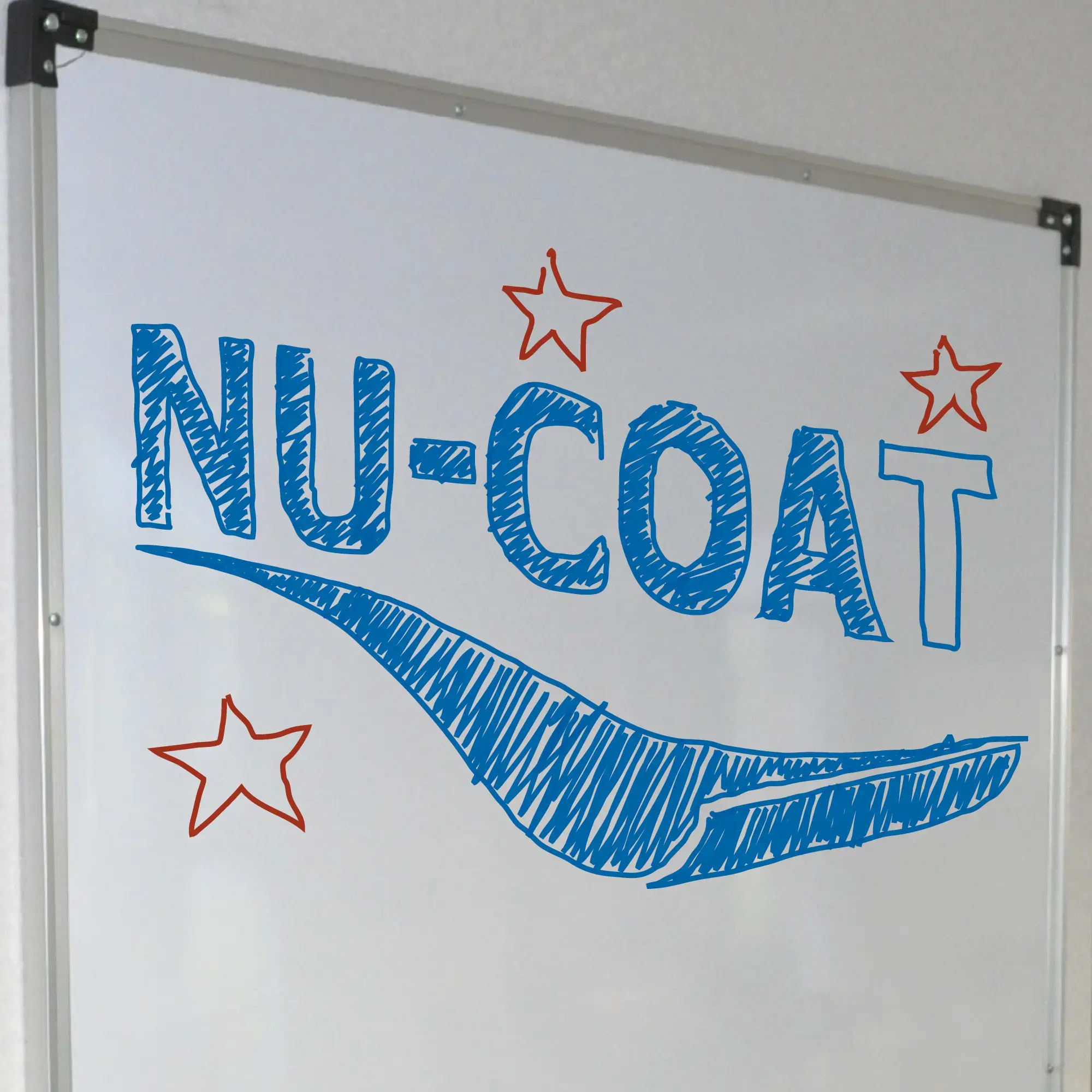 NU-COAT's T28-P gloss white dry-wipe whiteboard film laminated to a hard board backing and framed on a classroom wall with the NU-COAT logo and stars drawn on it in blue and red dry wipe pens.