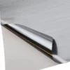 NU-COAT T80-P Brushed One-Way Silver self-adhesive film with the corner of the vinyl peeled back to reveal both sides of the film - the face side has a full brushed metal effect while the reverse (adhesive side) has a less visible brush effect, so when applied to a window the same finish would not be viewable from both sides of the glass.