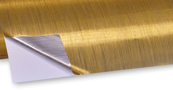 TSBG3 brushed gold self-adhesive print vinyl with a corner of the film peeled back to show the one-way brushed gold effect and silver brushed effect on the reverse side.