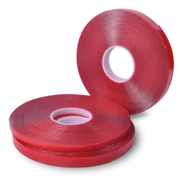 Clear double-sided ultra high bond sign tape, UHB-C-10F, shown in reeled rolls in the three different sizes, two of the reel widths are on their side, horizontally stacked on top of each other, and the third reel is offset to the side standing upright on it's short edge.