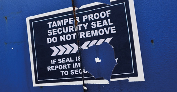 KPMF K74500 ultra-destruct safety sign vinyl has been applied onto an exterior blue skip door for the purpose of a tamper evident sticker where if seal is broken (vinyl stuck across the door is broken) you can easily see that in this case the door has been opened and should be reported to security.