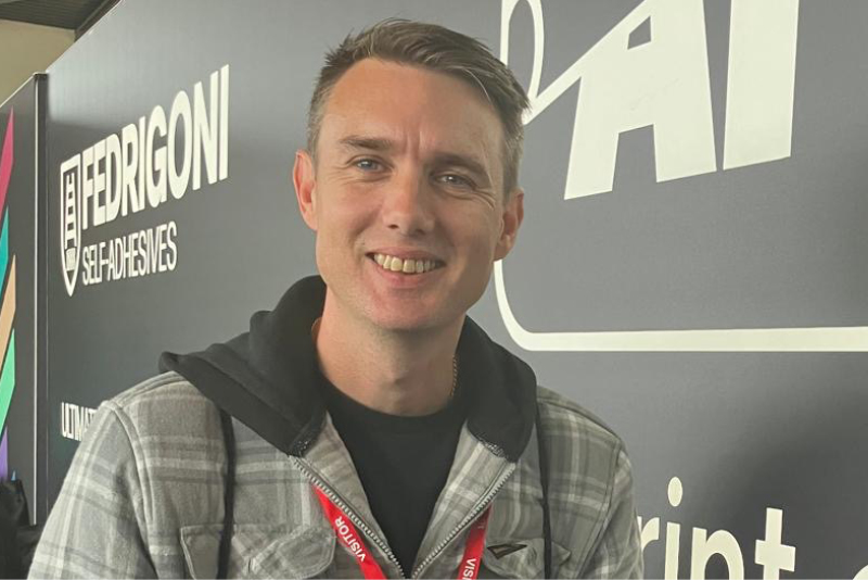 Nathan Squire of Full Circle/Squire Signs receiving his 2nd place winners voucher for his entry into our Wing Mirror Wrapping Competition on Friday 4th October, the final day of WrapFest 2024!