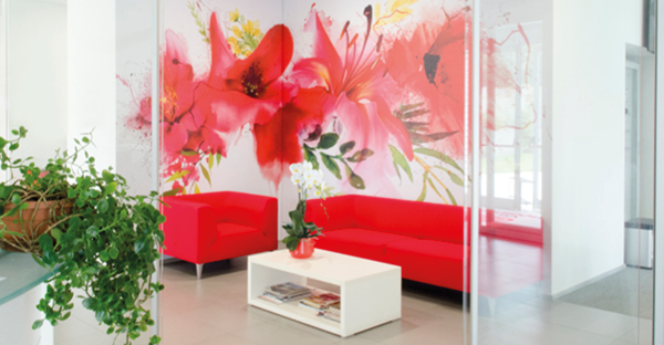 A beautifully designed, printed red and white poppy image on WW309 graphics vinyl, lending a touch of serenity and calm to this tastefully decorated waiting room wall with a complimentary red sofa, white furniture, plants and glass entrance doors to complete this reception area.