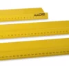 Bright yellow safety rulers laid one in front of the other ranging from small in the background to largest in the foreground in 3 sizes (500mm, 1000mm & 1500mm) - all featuring the significantly raised lip for finger protection along the cutting edge which is facing towards the camera, with a focus on the measurements.